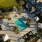 Resort-style pool with shaded cabanas and palm trees at Canopy community.