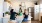 Friends gathered around a modern kitchen island with white cabinets, stainless steel appliances, and bright decor, enjoying a casual moment together