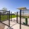 Open grassy park with walking paths and seating areas at Canopy community