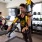 Residents working out in a fully equipped fitness center with TRX suspension training and stationary bikes at Canopy community