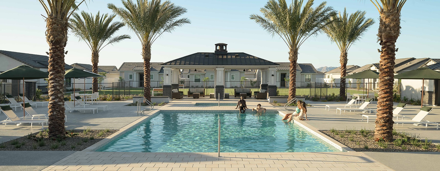 resort style pool with seating and a building behind